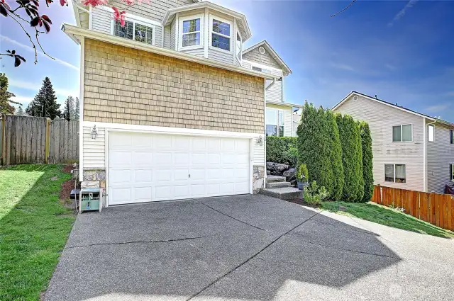 A view of the north front side of home and top driveway parking area.
