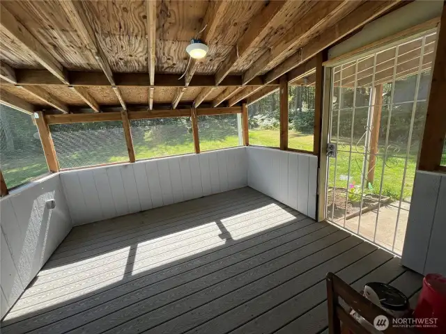 Enclosed back porch makes the perfect catio or place to relax