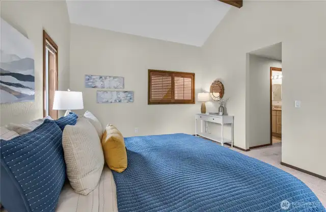 Upstairs original primary bedroom with vaulted ceilings.