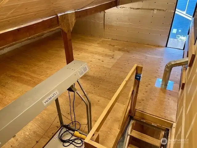 Pull-down stairs and motorized lift allow safe and efficient access to this space.