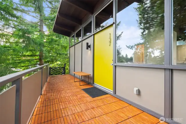 Natural wood slatted decking to front door. Beautiful.