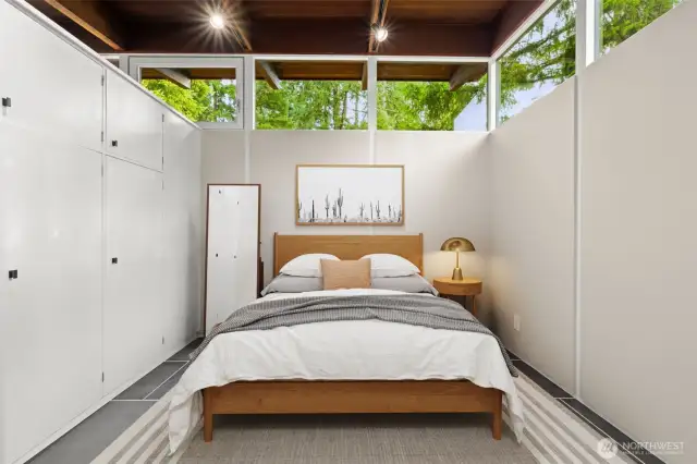 Virtually staged primary retreat designed with smart storage solutions, freeing the room from the need for extra furniture.