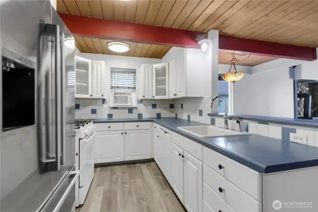 Light and bright kitchen-newer bosch diswaher and refrigerator.