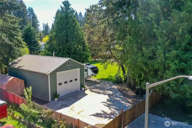 1000 sq ft shop with it's own driveway and gate. Notice the street lighting and RV parking. Shop has it's own heat, power and running water. You must see it to believe it.