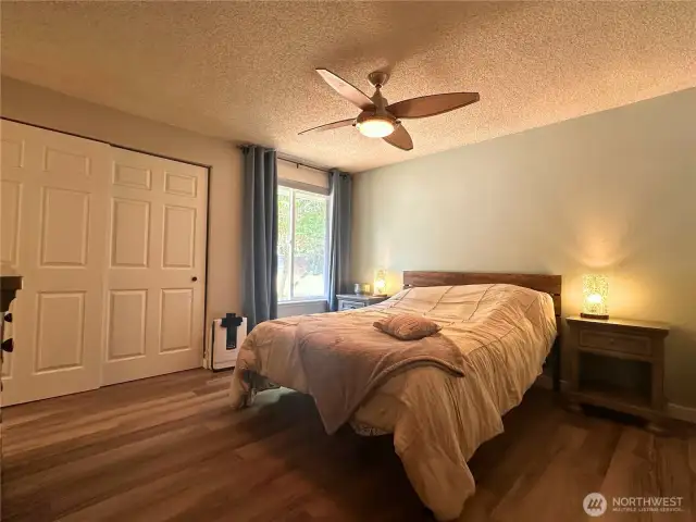Primary bedroom is spacious with a large closet, and ceiling fan.