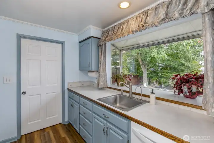Huge garden window in the kitchen brings in much natural light.