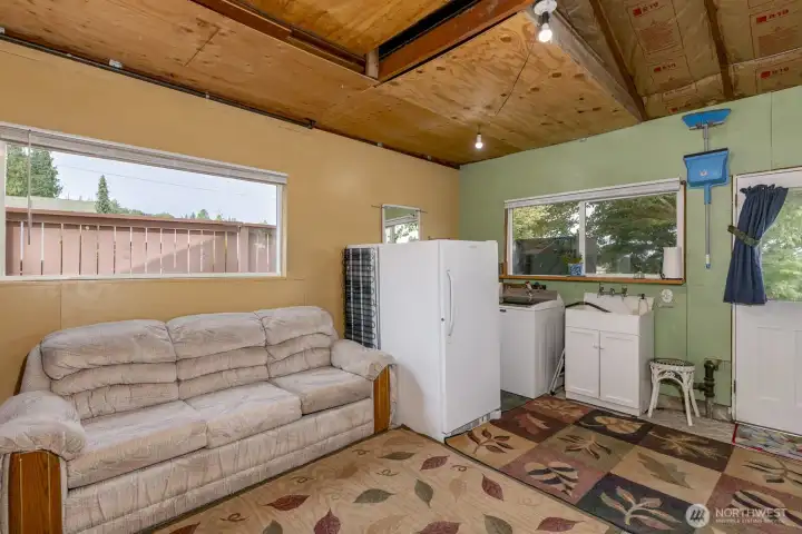 Area in garage has been partially finished for additional room.