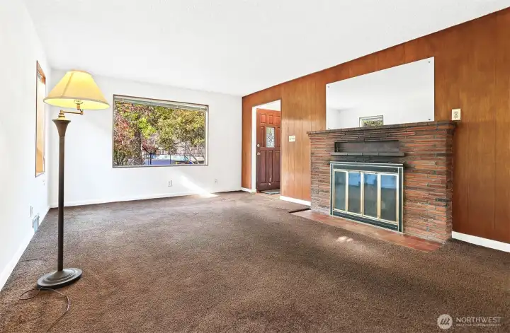 View of Livingroom and wood burning fireplace.