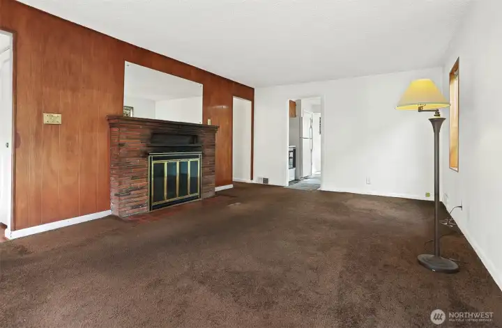 View of Livingroom and wood burning fireplace.