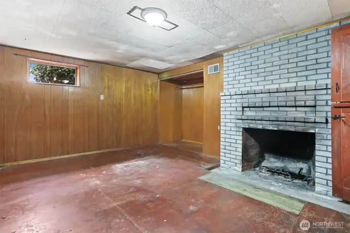 Bonus room in basement with fireplace.