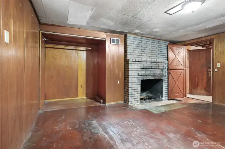 Bonus room in basement with fireplace.
