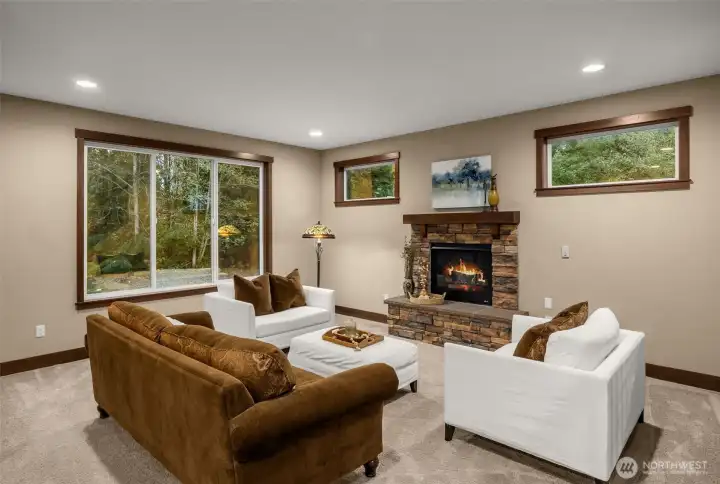 Your light and bright living room is surrounded by windows and a cozy gas fireplace.