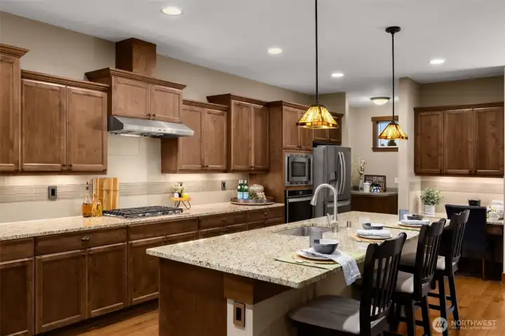Abundant storage behind these gorgeous kitchen cabinets. Under cabinet lighting provides perfect illumination for the workspace. Access the garage in the hall behind the frig. NOTE: the 3-car garage is fully covered with sport court tile. Perfect for a home gym! Or your car(s).