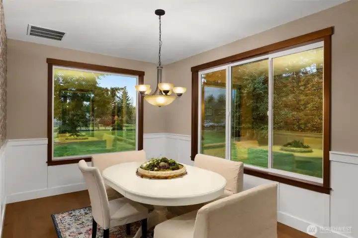 The formal dining room offers windows on 3 sides. Wainscoting adds elegance to this space.