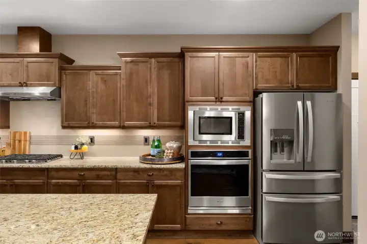 Slab granite counters, a gas cooktop and stainless-steel appliances complete this high-end kitchen.