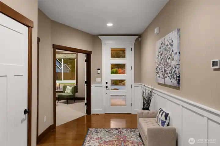 Oversized front door adds drama to the foyer, and a peek at the fall colors outside.