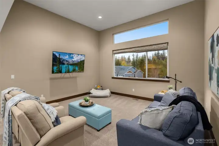 Upstairs, this large bonus room with clerestory window and vaulted ceiling offers a great space to relax.