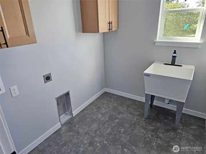 Large utility rm with cabinets and sink conveniently located upstairs near the bdrms