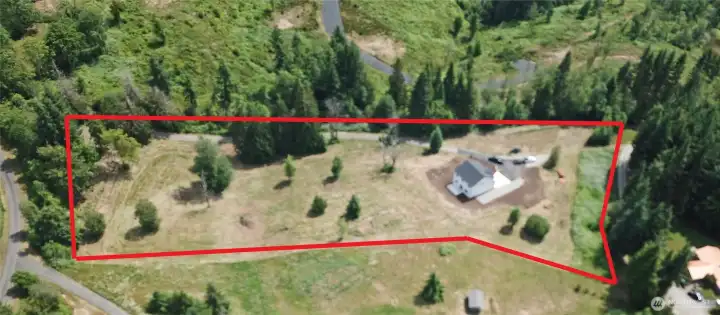 Majority of the site is cleared and mowed. Scattered trees dot the landscape