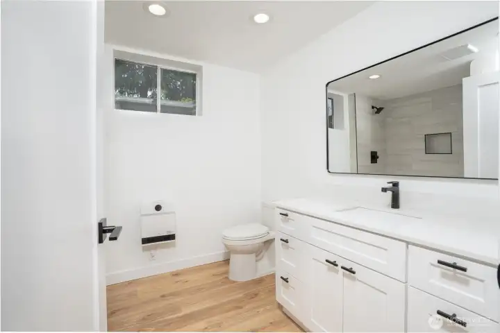 Downstairs Bathroom, with porcelain tile shower and quartz counter tops.