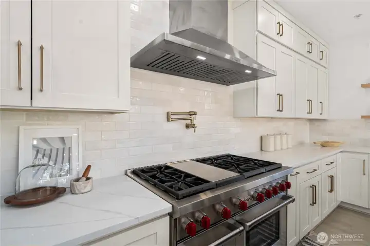 Premium appliances including WOLF cooktop with oven