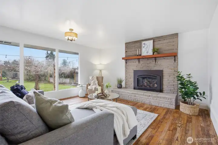 There is a gorgeous flagstone fireplace with a gas insert and an solid wood mantle, that makes for a lovely focal point in the living room.