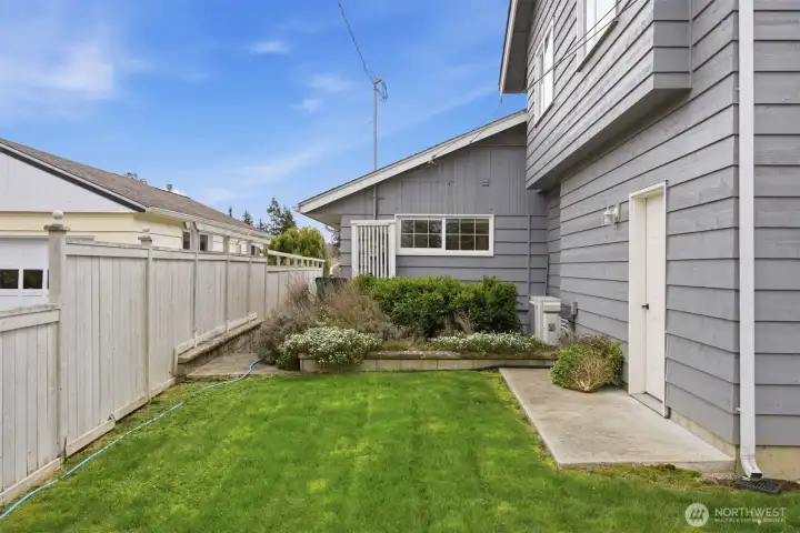 The landscape will begin blooming soon and it is a series of colors from spring to fall! This walkway leads to the large hot tub that remains with the sale of the home.