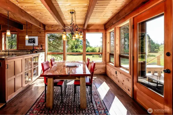 Dining area off kitchen. Custom cabinetry. Room faces Southeast and South for warm, inviting sun and light year round.