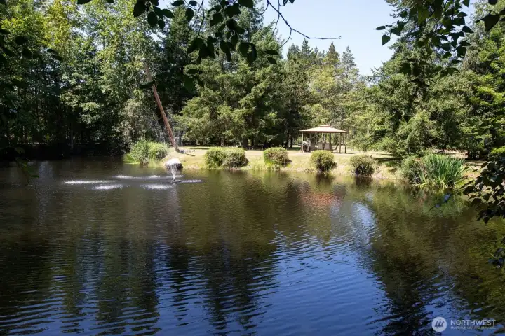 The tranquil pond has an aeration fountain. The seasonal gazebo overlooks the pond and rope swing.