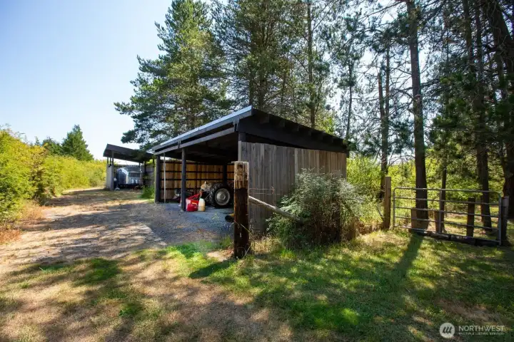 Yard equipment carport is tucked away from property at NE corner of property.