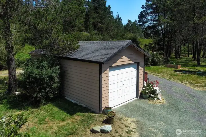 Single car garage is one of many outbuildings.