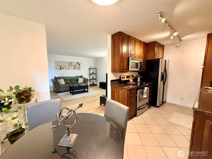 From the dining area, a view of the kitchen and beyond is the living room.