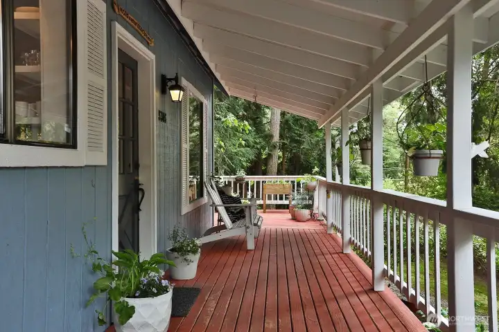 Charming entry via the covered porch. You have peek-a-boo views from here. Perfect spot for your morning cup of coffee!
