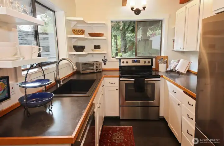 Charming kitchen with ceramic tile and a kitchen sink window that looks out upon the covered porch.