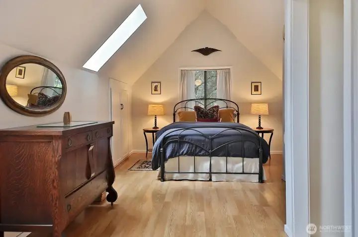 The doorway to the stairs is along the right edge of this photo. Sitting area/office is to your back. Two skylights in this bedroom.