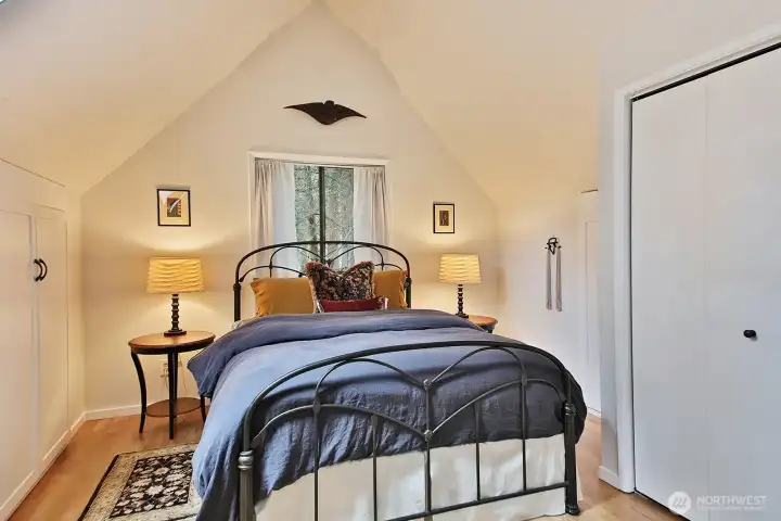 There are storage closets built into the eaves in addition to the closet along the right edge of the photo.