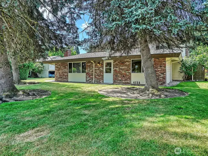 Perched back from the street and surrounded by trees, this special condo feels like a private retreat.