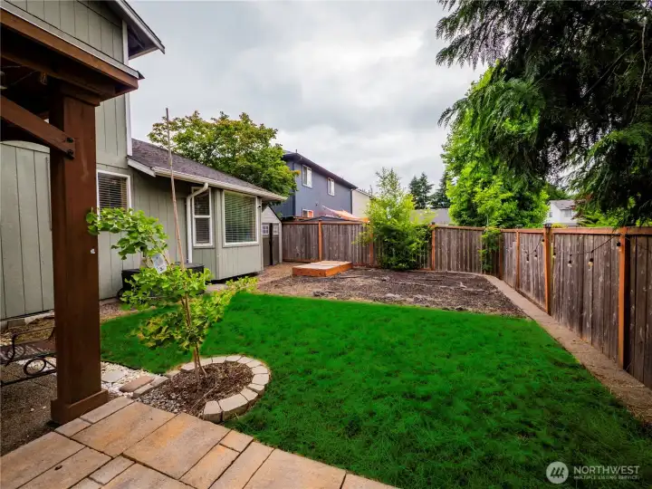 FENCED BACKYARD WITH STORAGE SHED TO THE LEFT