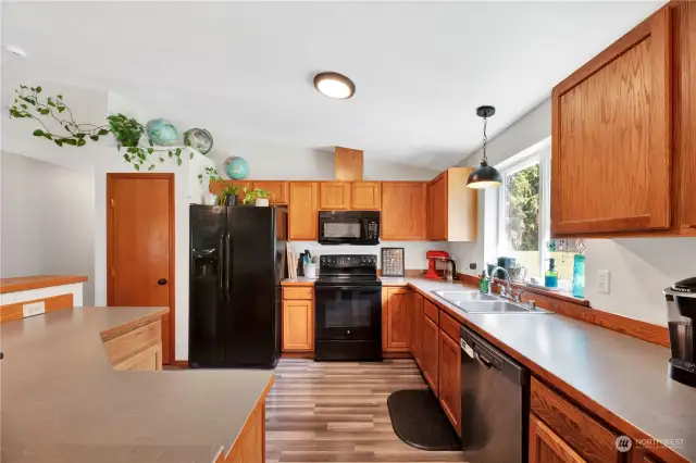 The kitchen has ample counter space, bar seating area and the appliances stay and the stove in almost new.
