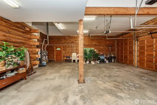 3 car garage with one 12 ft high door, storage area, central vacuum, 2 water heaters, and forced air furnace of heat pump.