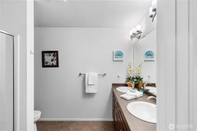 Private bath off primary suite with dual vanity and large walk in shower.