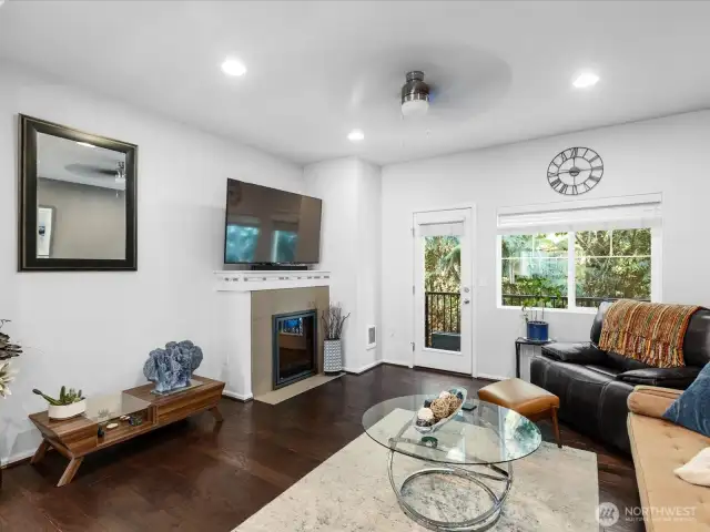 Living Room with cozy fireplace.  Windows overlook quiet green space.