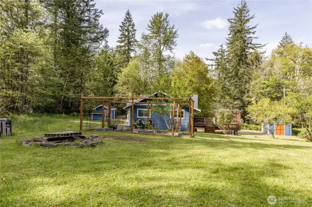 Plenty of space to play or relax on this shy acre property, including a fire pit and a partial mountain view!