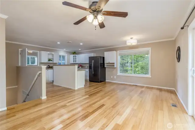 Living area with steps leading downstairs to the bonus room