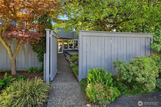 Welcome through your private gate to spacious, beautifully landscaped front yard.