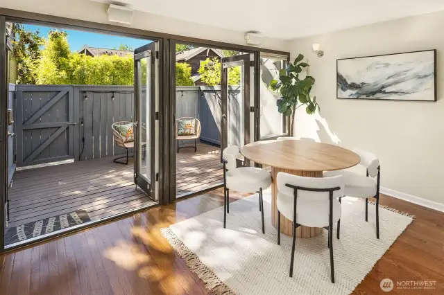 Open double french doors to extend dining area to sun-filled back deck.