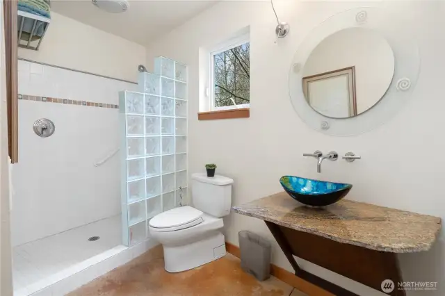 1221. Main floor bathroom features a step-in tiled shower and a granite counter with art glass sink.