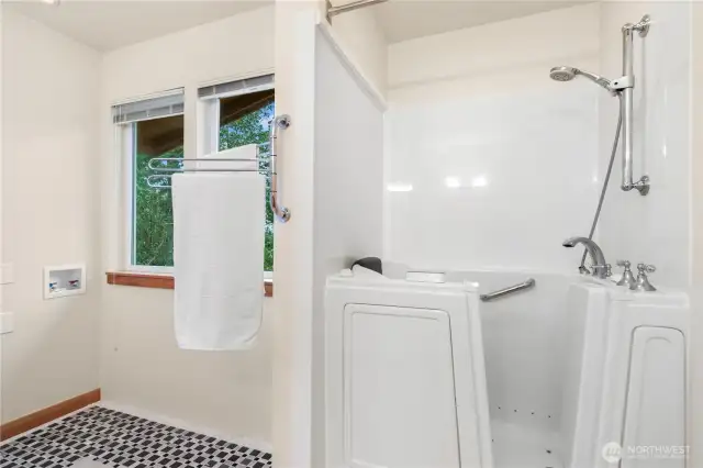 1221. Experience the luxury of a walk-in tub that includes a convenient shower option. Plus, the tiled area is perfectly designed for an upstairs washer and dryer, adding both functionality and style to your home.