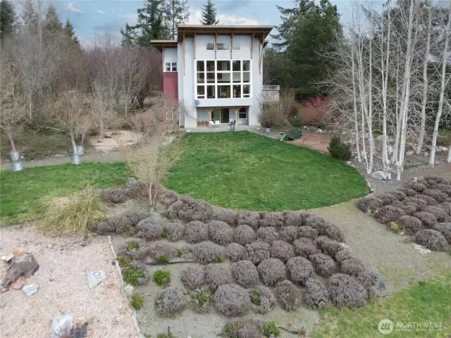 1221. View of the gardens and the house beyond. Those plants in front are lavender plants.