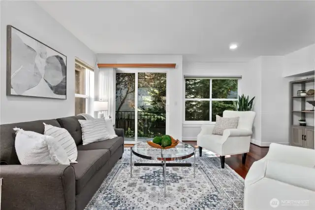 Living room area with big windows and deck access.